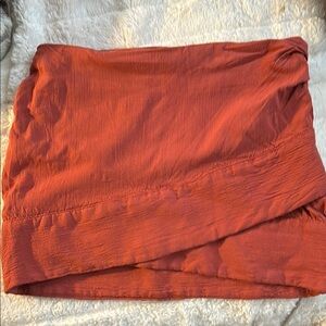 Free People size 2. Elegant Rust Skirt with criss cross in front.